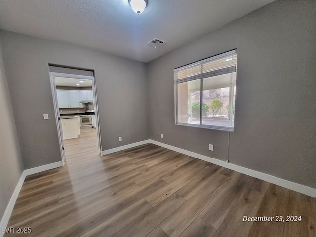 spare room featuring light hardwood / wood-style floors