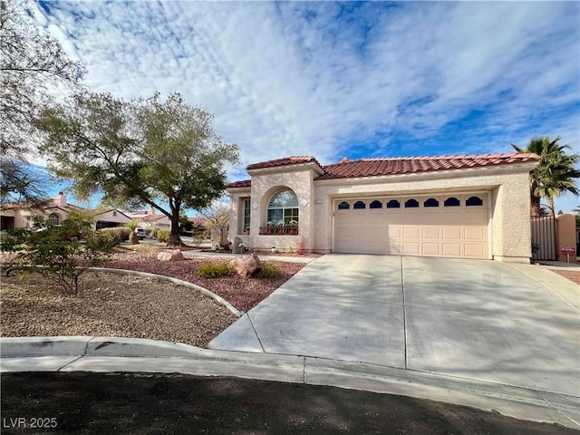 mediterranean / spanish home featuring a garage