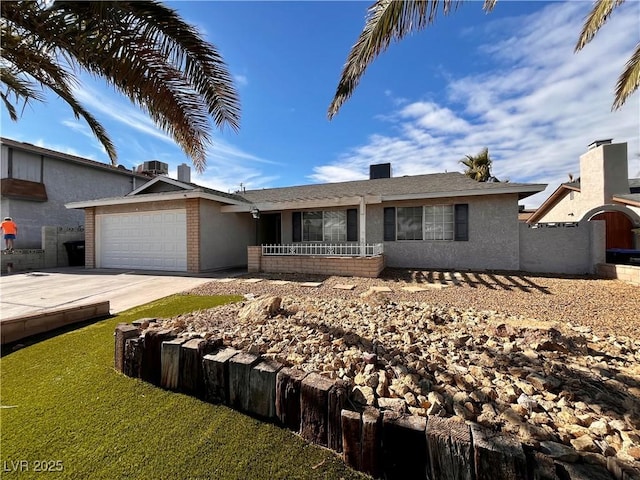 ranch-style house featuring a garage and central air condition unit