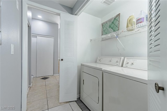 laundry room with light tile patterned flooring and independent washer and dryer