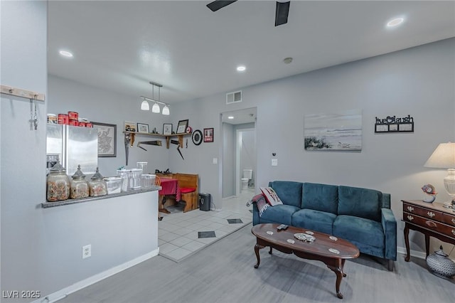 tiled living room featuring ceiling fan