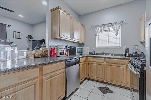 kitchen with kitchen peninsula, appliances with stainless steel finishes, sink, light brown cabinets, and light tile patterned floors