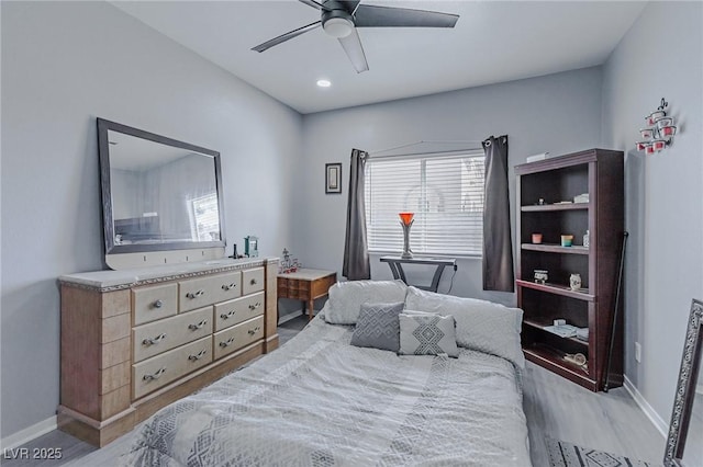 bedroom with light hardwood / wood-style flooring and ceiling fan