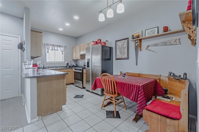 kitchen featuring decorative light fixtures, light tile patterned flooring, light brown cabinetry, and appliances with stainless steel finishes