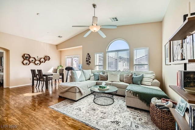 living room with hardwood / wood-style floors, ceiling fan, a wealth of natural light, and vaulted ceiling