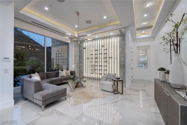 interior space with a notable chandelier and a raised ceiling