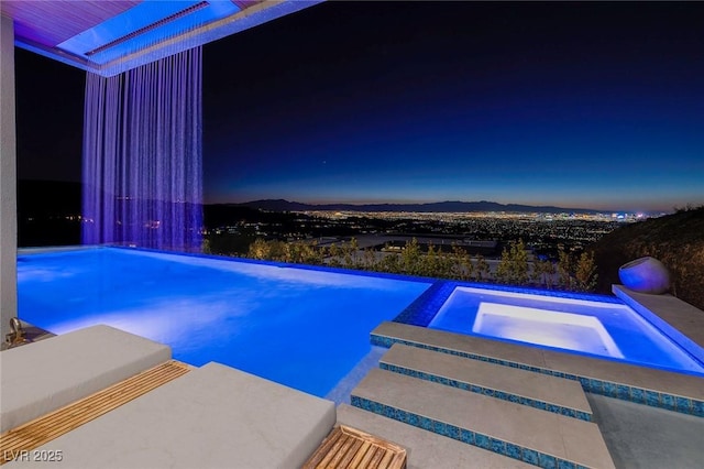 view of pool featuring an in ground hot tub