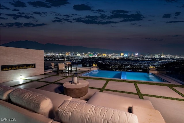 view of swimming pool featuring a mountain view, an outdoor hangout area, and a patio