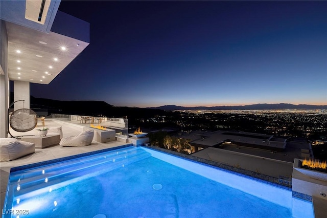 pool at dusk with a mountain view