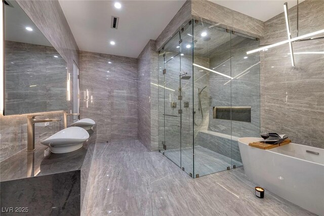 bathroom featuring separate shower and tub and tile walls