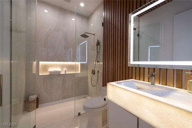 bathroom with tile patterned floors, toilet, vanity, and walk in shower