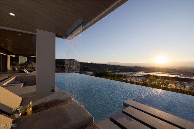 view of pool at dusk