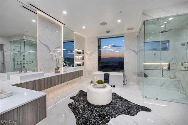 bathroom featuring vanity and a shower with shower door