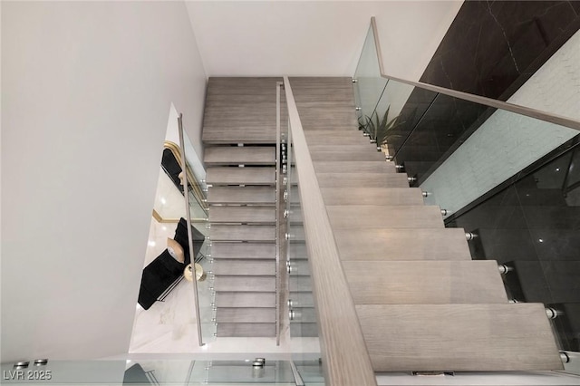 staircase with a towering ceiling