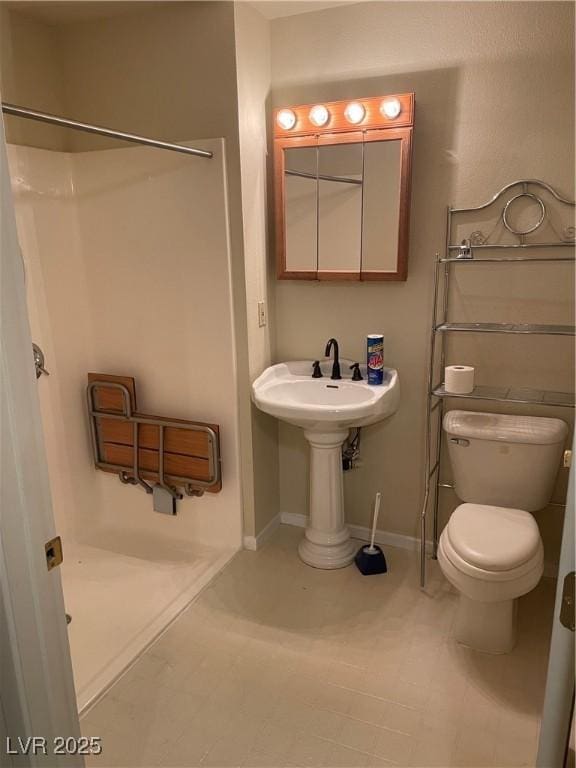 bathroom with a shower and toilet