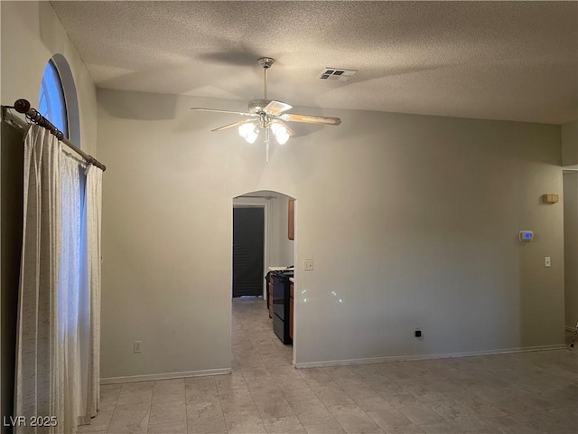 unfurnished room with a textured ceiling and ceiling fan