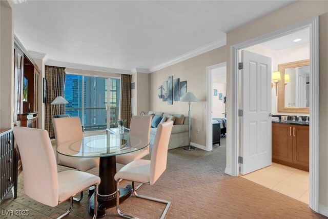 dining space with crown molding and light carpet