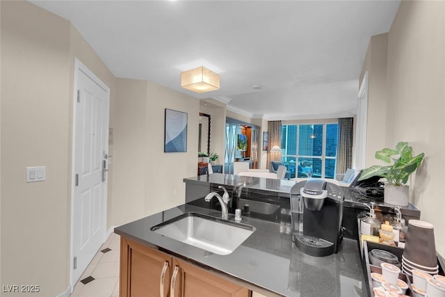 kitchen featuring light tile patterned floors and sink