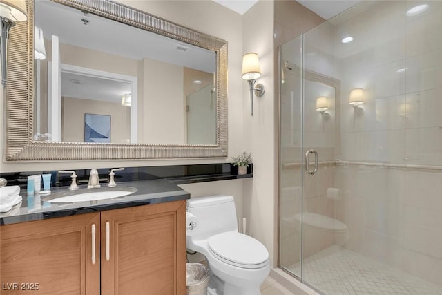 bathroom with vanity, toilet, and a shower with shower door