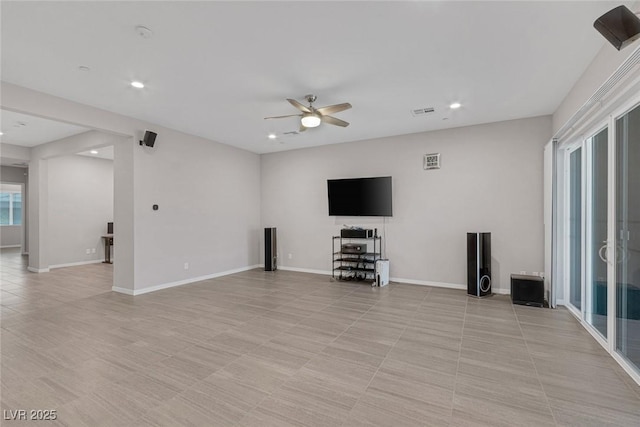 unfurnished living room featuring light tile patterned floors and ceiling fan