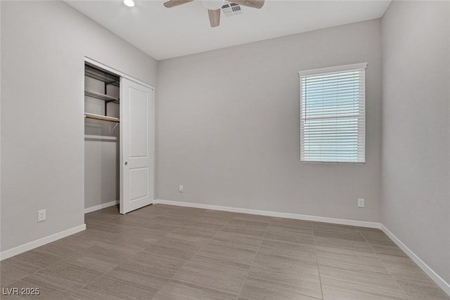 unfurnished bedroom featuring ceiling fan, a closet, and light tile patterned floors