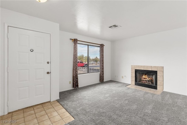 unfurnished living room with light carpet and a fireplace