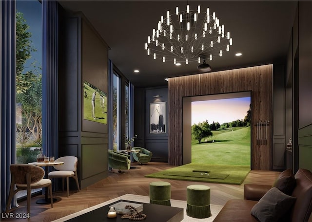 interior space with golf simulator, a notable chandelier, and parquet flooring