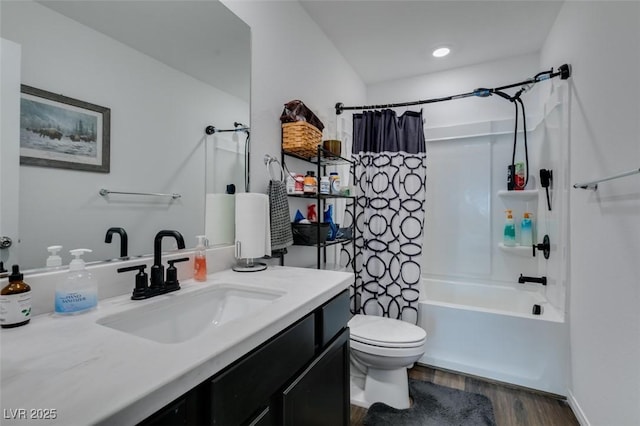 full bathroom with shower / tub combo with curtain, hardwood / wood-style floors, vanity, and toilet