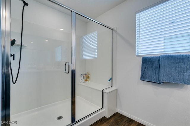 bathroom with hardwood / wood-style flooring and walk in shower