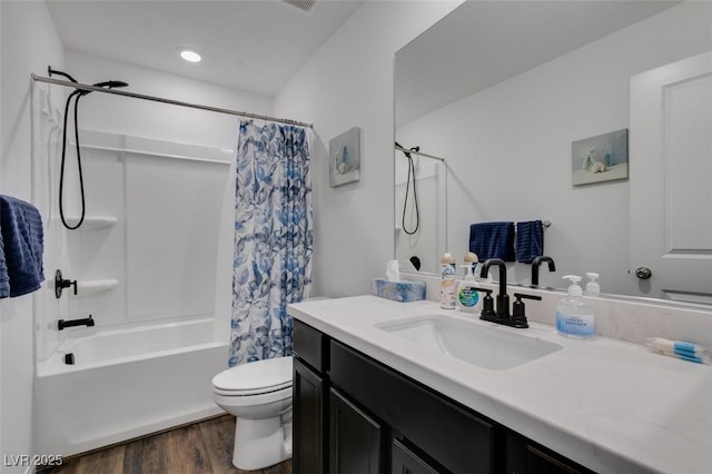 full bathroom with vanity, hardwood / wood-style flooring, shower / bath combo, and toilet