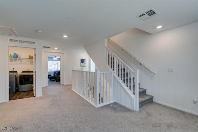 hall featuring carpet floors and washing machine and dryer