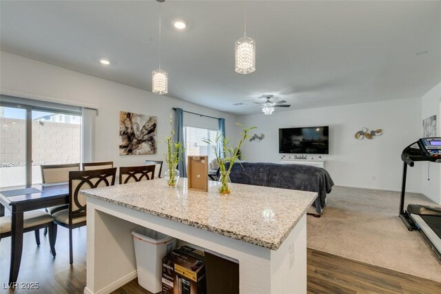 kitchen with hanging light fixtures, dark hardwood / wood-style floors, a wealth of natural light, and ceiling fan