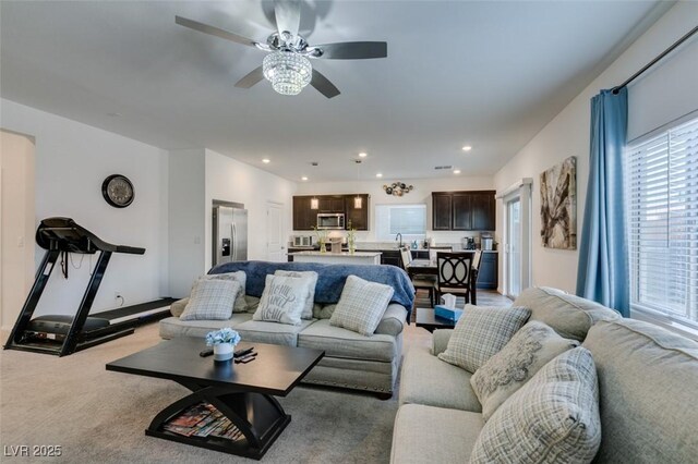 living room featuring ceiling fan and light colored carpet