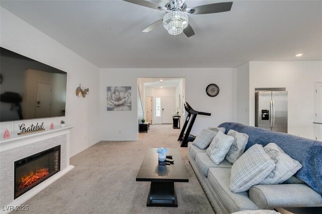 carpeted living room featuring ceiling fan