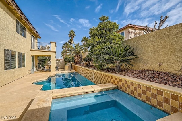 view of swimming pool featuring an in ground hot tub