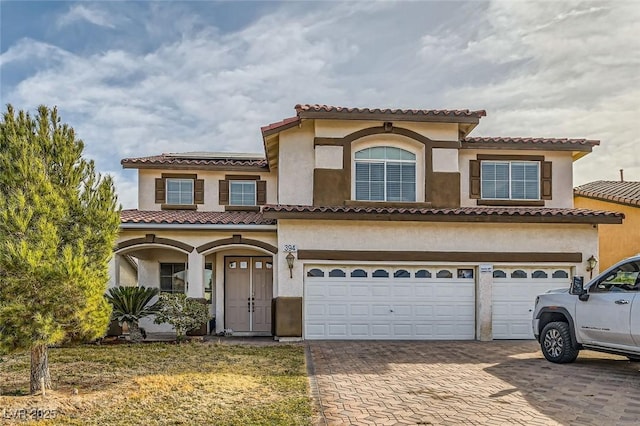 mediterranean / spanish house featuring a garage