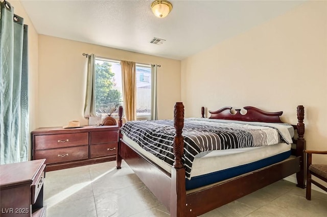 bedroom featuring light tile patterned floors