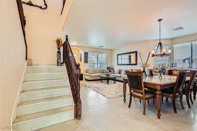 tiled dining space featuring a notable chandelier