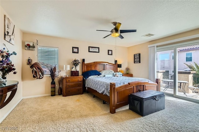 bedroom with ceiling fan, light carpet, multiple windows, and access to outside