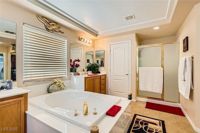 bathroom with tile patterned floors, vanity, and separate shower and tub