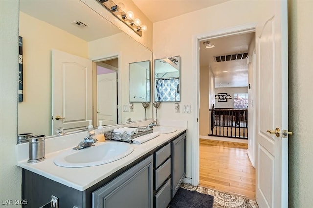 bathroom with vanity and wood-type flooring