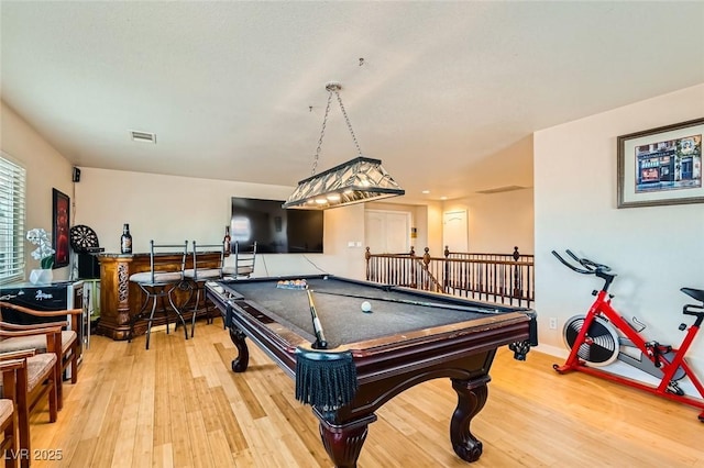 playroom featuring pool table, wood-type flooring, and bar area