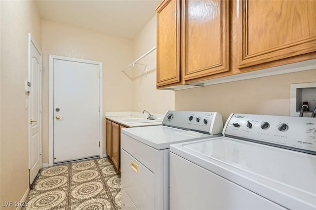 washroom with cabinets, washing machine and dryer, sink, and light tile patterned floors