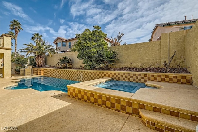 view of swimming pool with a patio and an in ground hot tub