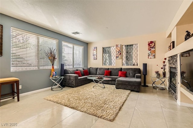 living room featuring a fireplace and a textured ceiling