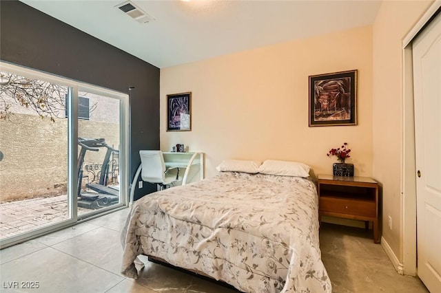 bedroom with access to exterior and tile patterned floors