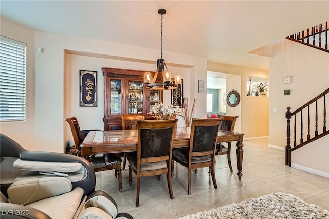 tiled dining room featuring a chandelier and a wealth of natural light