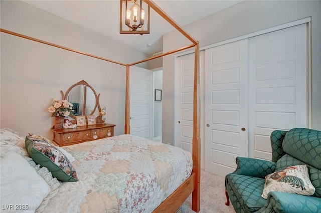 bedroom with carpet floors and an inviting chandelier