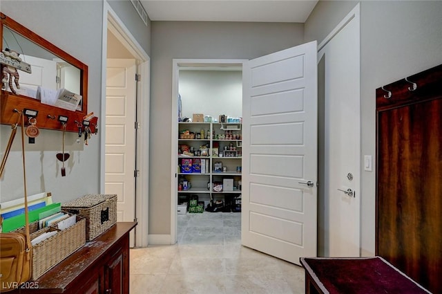 corridor with light tile patterned floors