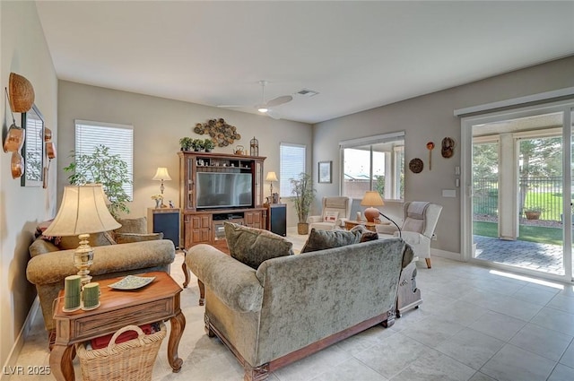 living room featuring ceiling fan and light tile patterned floors